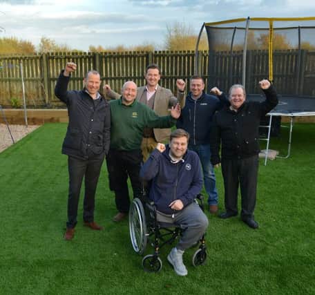 Johnnie Meechan with some of the tradespeople who helped with the makeover. Picture: Jon Savage