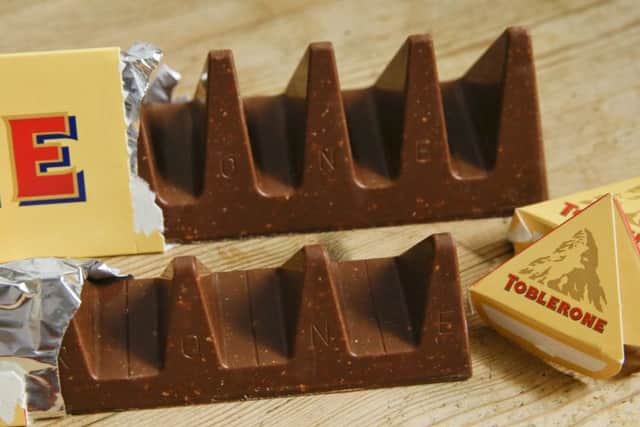 In this photo illustration two bars of the Toblerone Swiss chocolate are shown, at front is the new style 150 gram bar showing the reduction in triangular pieces. (AP Photo/Alastair Grant)