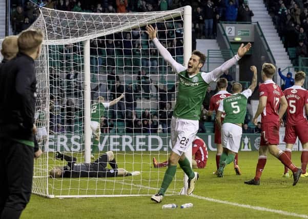 Brian Graham, who scored the first goal, celebrates as David Gray makes it 3-0 against Queen of the South at Easter Road. Pic: SNS