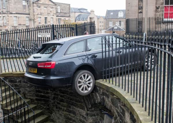 An Audi A4 crashed through a fence on Broughton Place after the automatic handbrake failed to activate Picture; Ian Georgeson
