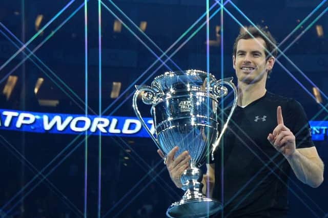 Andy Murray poses holding the ATP World Number One trophy after defeating Novak Djokovic. Picture: AFP/Getty Images