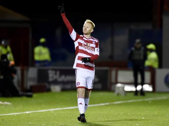 Ali Crawford had an eventful night on Monday against Hearts, scoring a free-kick but also putting in a dangerous tackle on Jamie Walker. Pic: SNS