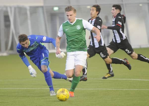 Jason Cummings rounds Cammy Gill to open the scoring for Hibs. Pic: Greg Macvean