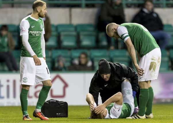 Hibs midfielder Fraser Fyvie, on ground, is a major doubt for Friday's clash with Dundee United