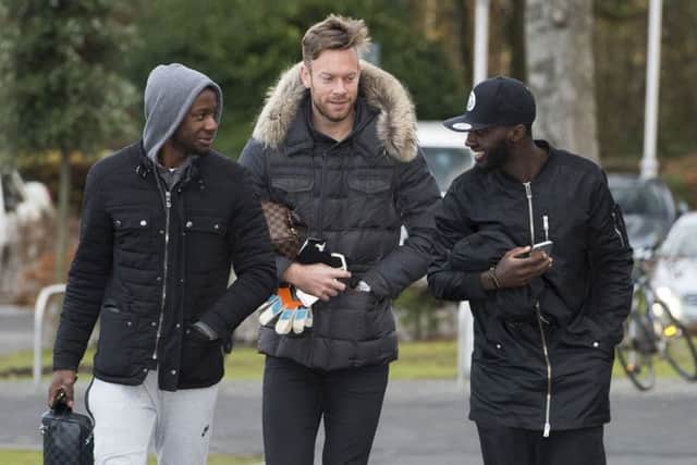 Arnaud Djoum, left, arrives at Hearts training with Viktor Noring and Prince Buaben