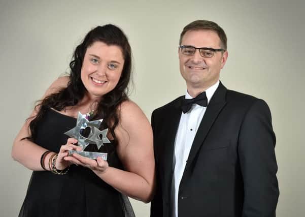 Louise Ross, winner of Care Uk's Nurse of the Year award, recieves her trophy from Care UK managing director Andrew Knight.