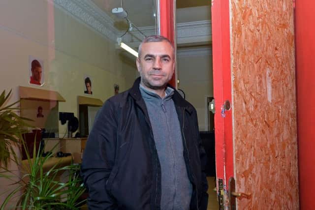 Yilmaz Pamuk outside the barbers where he works. Picture; Jon Savage