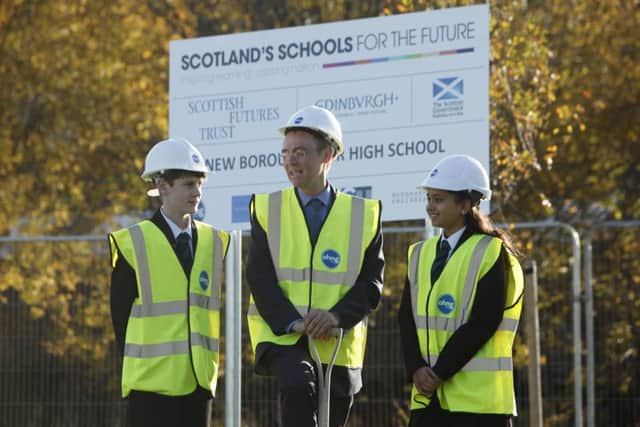 Minister Alisdair Allan, centre, helps break ground at the site of the new Boroghmuir High School. Picture: Toby Williams