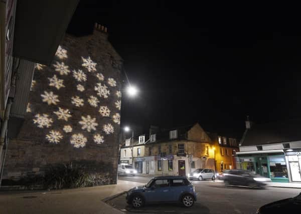 The snowflake is projected onto the building on the other side of the street. Picture: Greg Macvean