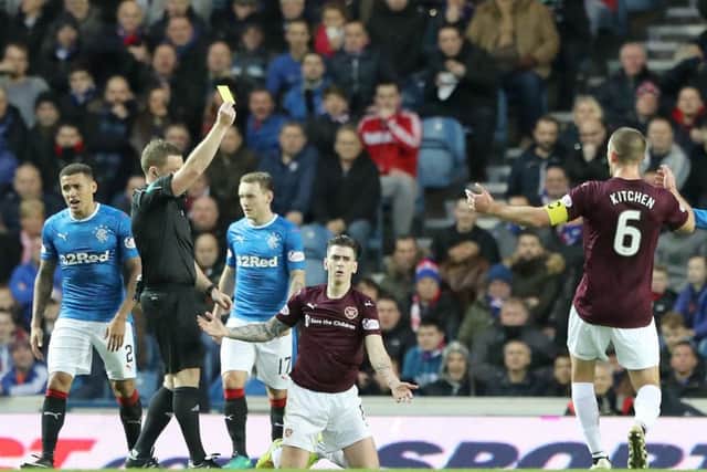 Jamie Walker is shown the yellow card at Ibrox