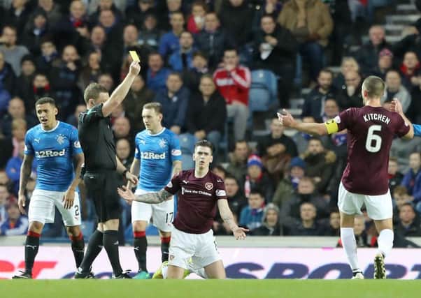 Jamie Walker is shown the yellow card at Ibrox