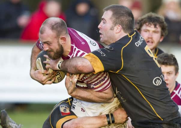 Watsonians' Rory Drummond is tackled by Currie captain Ross Weston.   Picture: Ian Rutherford