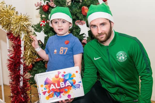 James Keatings met Jude Morgan, 4, from Penicuik as the Hibs players visited the Royal Hospital for Sick Children. Pic: Ian Georgeson