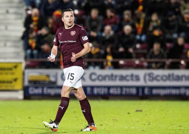 Don Cowie  Hearts oldest player  was seen trying to calm the Hearts support during the draw with Partick Thistle. Pic: SNS