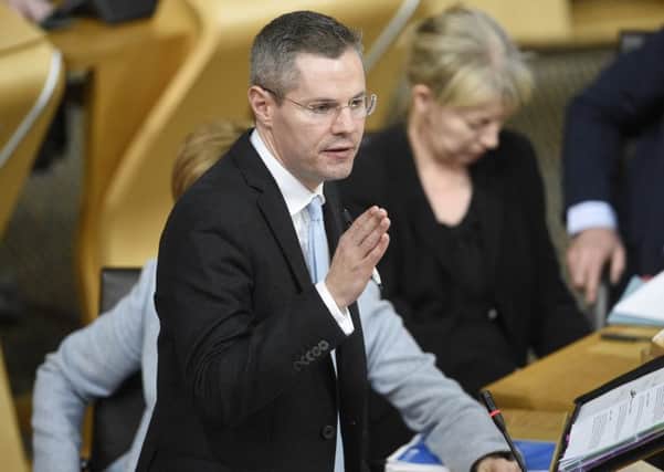 Finance Secretary Derek Mackay unveils his draft budget at Holyrood, in which the money allocated to local councils was cut by Â£327m. Picture: Greg Macvean