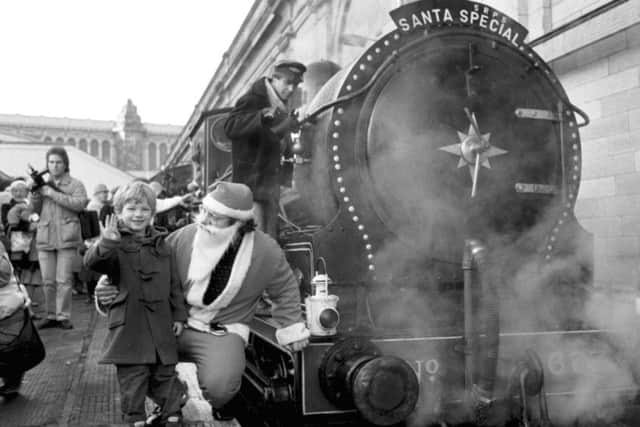 Michael Fielden (4) and Father Christmas at Waverley station beside the Santa Special in December 1986. Picture: TSPL
