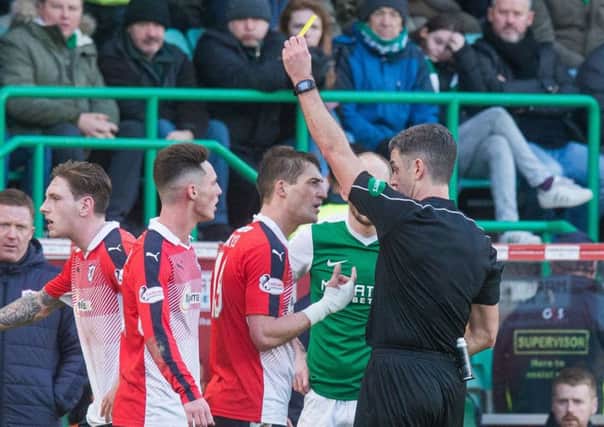 Ex-Hearts player Rudi Skacel was shown a yellow card for his challenge on Dylan McGeouch and later made a 5-1 gesture to home fans, below. Pic: Ian Georgeson