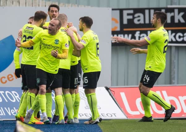 Hibs players rush to congratulate Kris Commons after his scorching free-kick clinched victory for Hibs. Pic: SNS