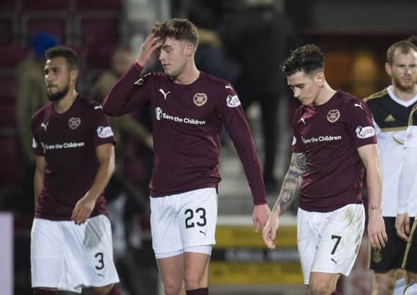 From left, Hearts players Faycal Rherras, Robbie Muirhead and Jamie Walker trudge off after defeat by Aberdeen. Pic: SNS