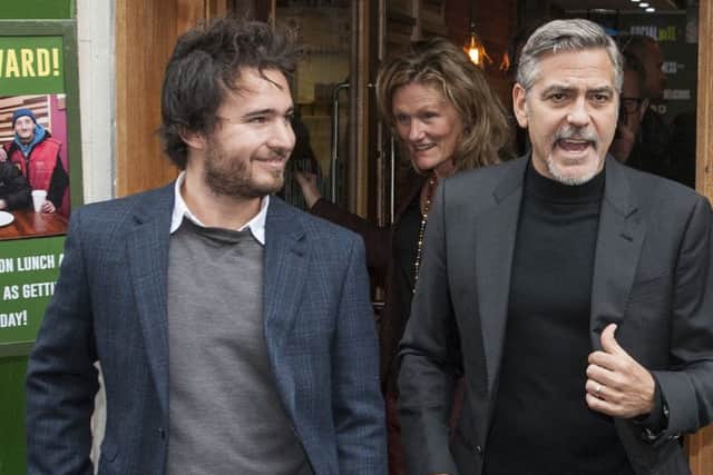 Josh Littlejohn, seen here with actor George Clooney, will be awarded an MBE. Picture: Phil Wilkinson