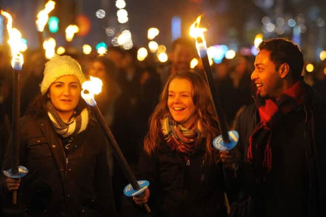 Members of the public take part in a torchlight procession through the streets of Edinburgh on December 30. Picture: Getty