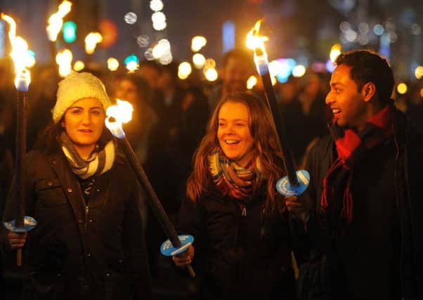 Members of the public take part in a torchlight procession through the streets of Edinburgh on December 30. Picture: Getty