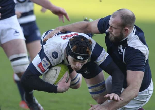Heriot's Martin Hughes is tackled by Rory Drummond of the Co-Optimists. Pic: Neil Hanna