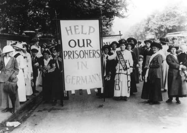 A crowd of female protestors hold a placard which reads 'Help Our Prisoners in Germany', circa 1914. Picture: GETTY