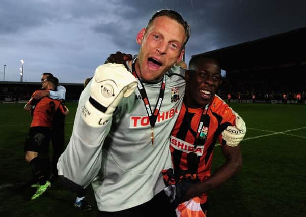 Graham Stack celebrates achieving promotion with Barnet FC from the Vanarama Football Conference to League Two in April 2015