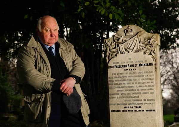 Edward Flint at the gravestone of Lieut Frederick Ramsay Walker which has recently been repaired. Picture: Scott Louden