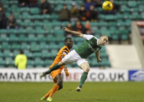 David Gray beats Tope Obadeyi to the ball last Friday. Gray has warned that standards must be maintained against Dumbarton
