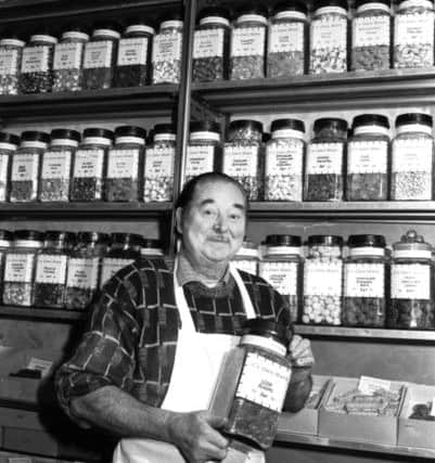 Edinburgh sweet shop owner and confectioner Jimmy Casey with a jar of soor plooms, February 1988.