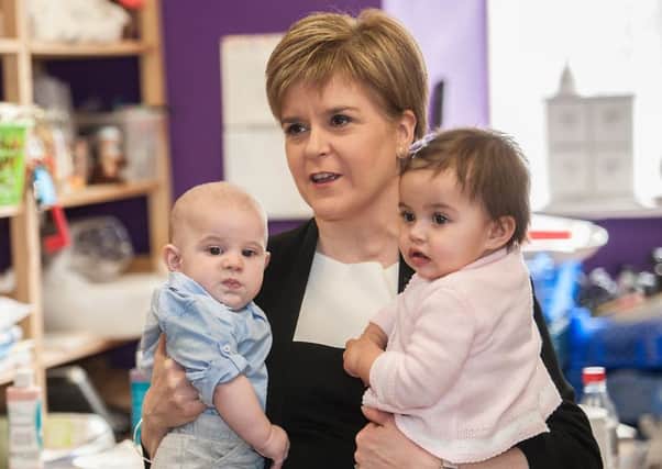 First Minister Nicola Sturgeon launches the Baby Box scheme with the help of little Leo Donegan and Nina Fredricks. Picture: John Devlin