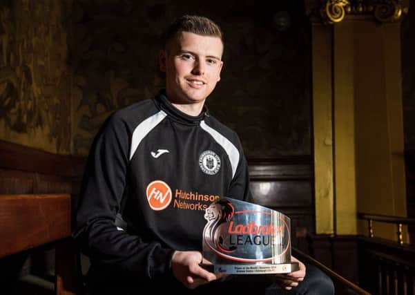 Andrew Stobie proudly shows off his Ladbrokes League Two player of the month award