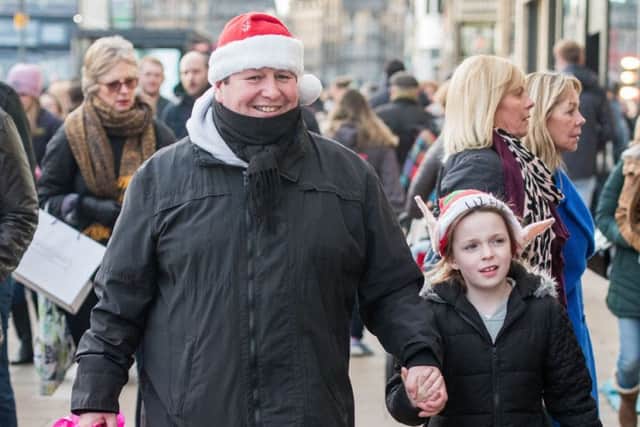 Scott Findlay and Molly Shaw, seven, enjoy Christmas shopping on Princes Street. Picture: Ian Georgeson