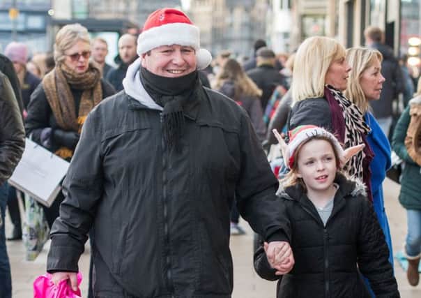 Scott Findlay and Molly Shaw, seven, enjoy Christmas shopping on Princes Street. Picture: Ian Georgeson