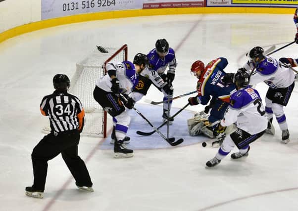 Mason Wilgosh is crowded out by Braehead Clan players at Murrayfield