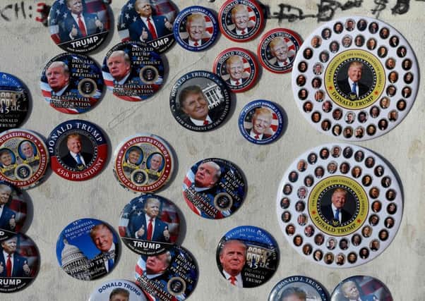 Souvenir Trump inauguration badges on sale at a stand near the White House . Picture: AFP