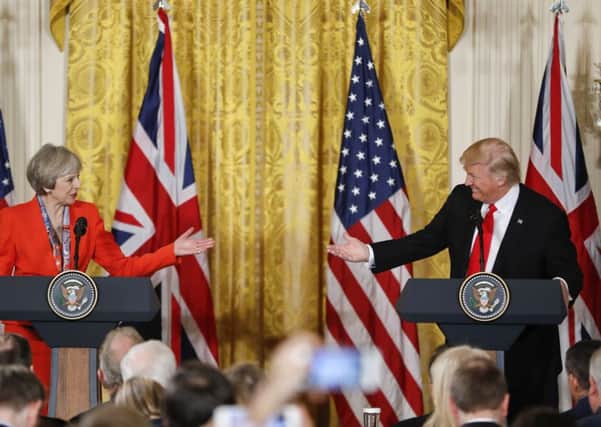 Mrs May and Mr Trump speak to reporters. Picture: AP