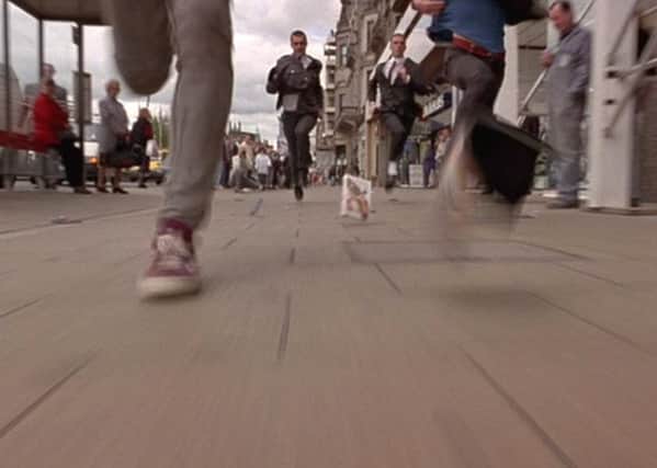 The famous opening scene features Renton and Spud running down Princes Street after stealing goods from John Menzies. Picture: Film4.
