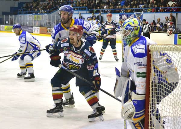 Capitals' Matt Tipoff, waiting for the pass, gets close attention from Fife's Phillipe Paquet
