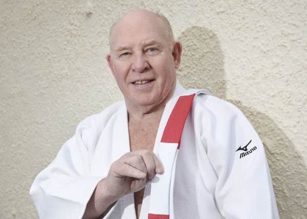 Andy Malcolm with his red and white belt for 6th dan status. Picture: Greg Macvean