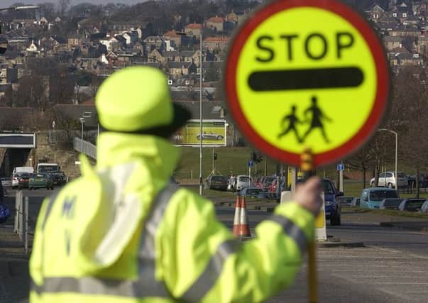 Don't get into a fight with a determined lollipop lady. Picture: Toby Williams