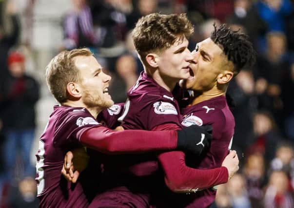 Rory Currie, centre, is congratulated on scoring his first senior goal for Hearts
