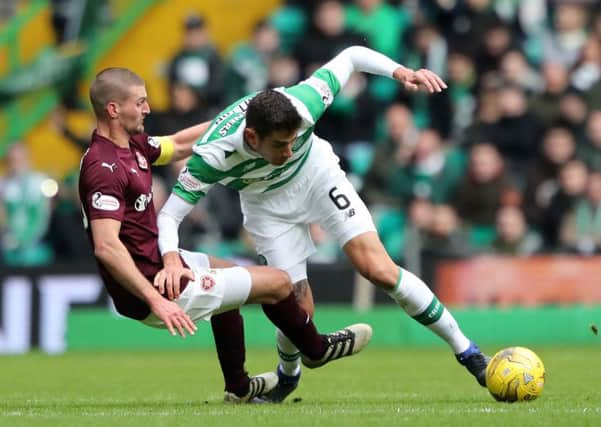 Perry Kitchen challenges Celtic's Nir Bitton. Picture: Andrew Milligan/PA Wire