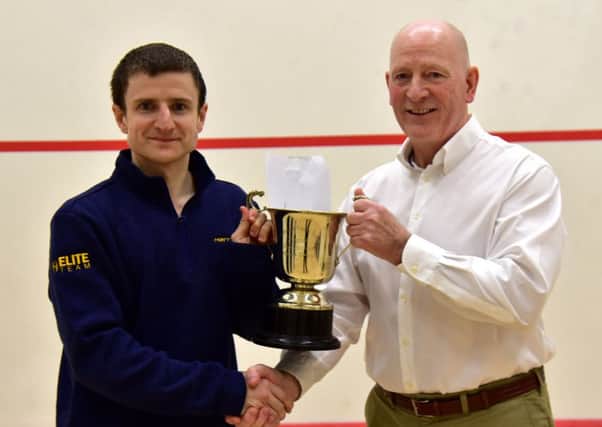 Alan Clyne, left, receives his trophy from Jim Hay, president of Scottish Squash and Racketball. Pic: Steve Cubbins