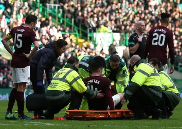 Hearts defender John Souttar is stretched off injured during the 4-0 defeat by Celtic. Pic: PA