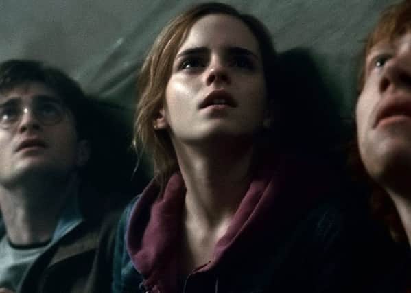 In this film publicity image released by Warner Bros. Pictures, from left, Daniel Radcliffe, Emma Watson and Rupert Grint are shown in a scene from "Harry Potter and the Deathly Hallows: Part 2." (AP Photo/Warner Bros. Pictures)