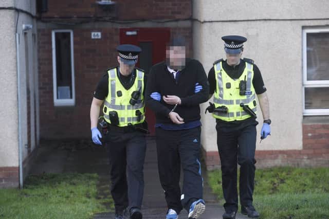 Police perform dawn raids on drug dealers - a dealer is arrested from his flat in Longstone Street. Picture; Greg Macvean