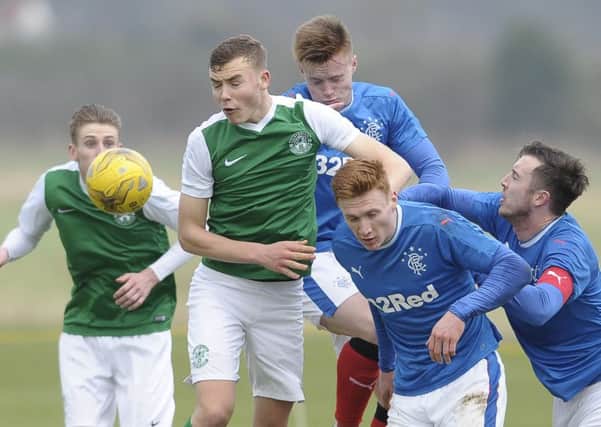 Rangers defender Danny Wilson, far right, tries to challenge Hibs' Ryan Porteous for possession. Pic: Neil Hanna